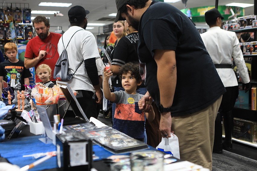 Seth and Cesar Vicuna pick up lollipops.