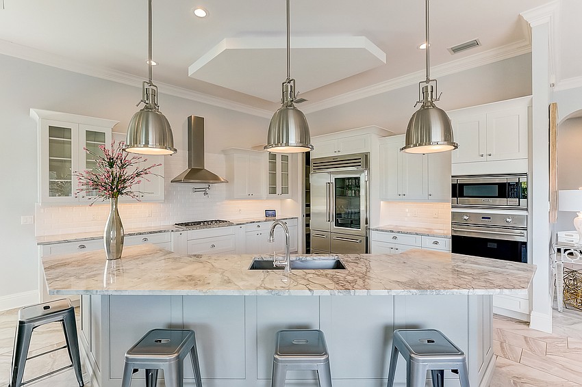 The chef's kitchen features  a granite island, an open pantry and seating room. (Photos courtesy Melissa Perrigoue with Coldwell Banker Realty)
