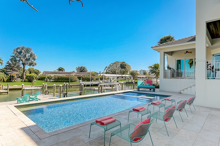 The property's canal dock is built to include a boat lift and storage/launching facilities for kayaks and paddleboards. (Photos courtesy Melissa Perrigoue with Coldwell Banker Realty)