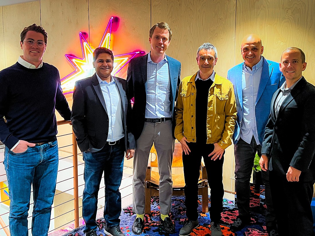 Koray Ozcubukcu, third from right, in yellow jacket, with the Blue.cloud executive team. (Courtesy photo)