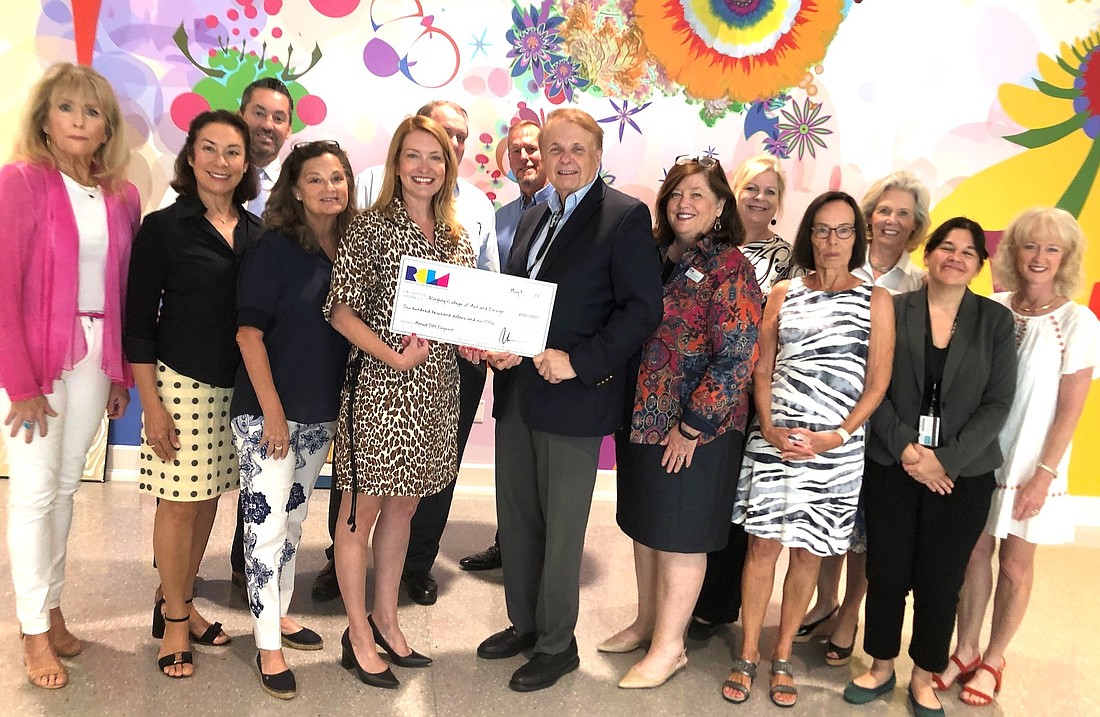 The RCLA Board of Directors and President Emily Walsh present Ringling College President Larry Thompson with a check for $600,000 to support the Alfred R. Goldstein Library and student scholarships.
