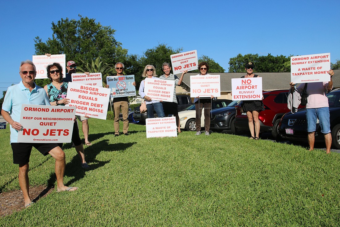 Residents protested the airport runway extension prior to the OB Life meeting on Tuesday, May 10. Photo by Jarleene Almenas