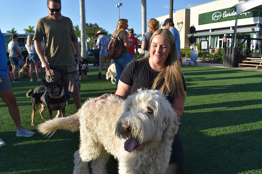 River Club resident Nicole Hackel and her Labradoodle, Bentley, enjoy The Green.