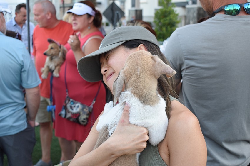 Linh Hoang from New York holds Buoy. Hoang is visiting her sister, Ling Le, on Cattleman Road.