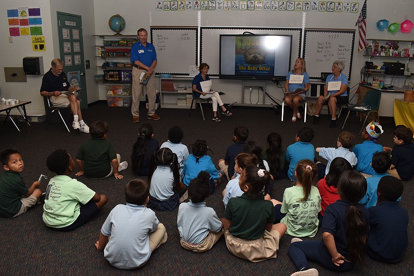 Kids settle in to hear the story.