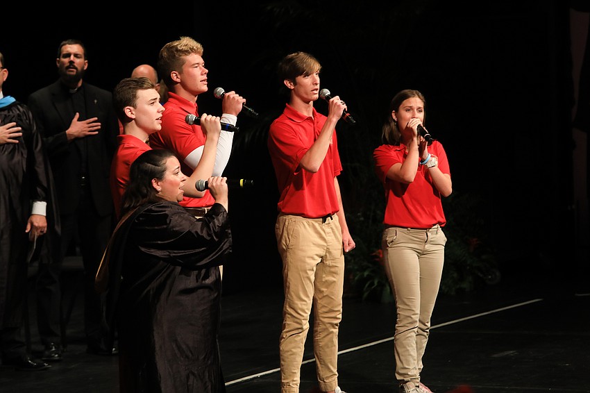 Matt Compa, Cooper Flerlage, Gage Hassler, Perla Pelegrin-Santos and Ella Schaefer of the Cardinal Mooney Musical Theatre sing the national anthem.