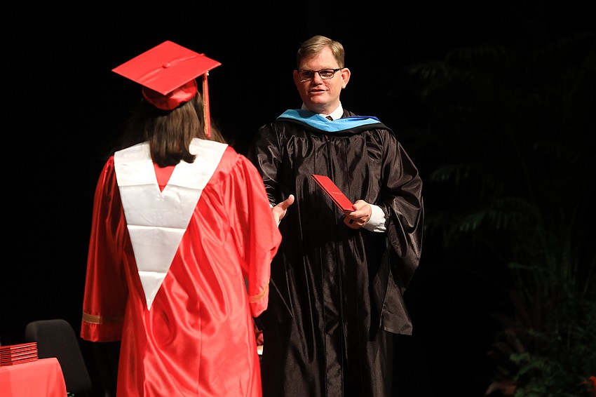 Principal Ben Hopper welcomes graduates to receive their diploma.