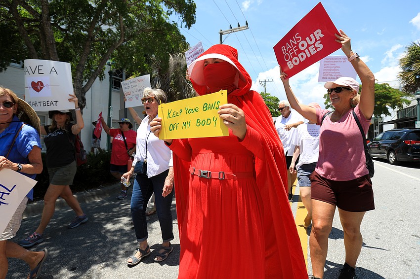 Caroline Rickerson wears a Handmaid's Tale costume for the march.