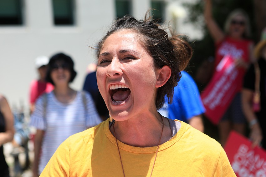 Destani Irland leads chants with the crowd.