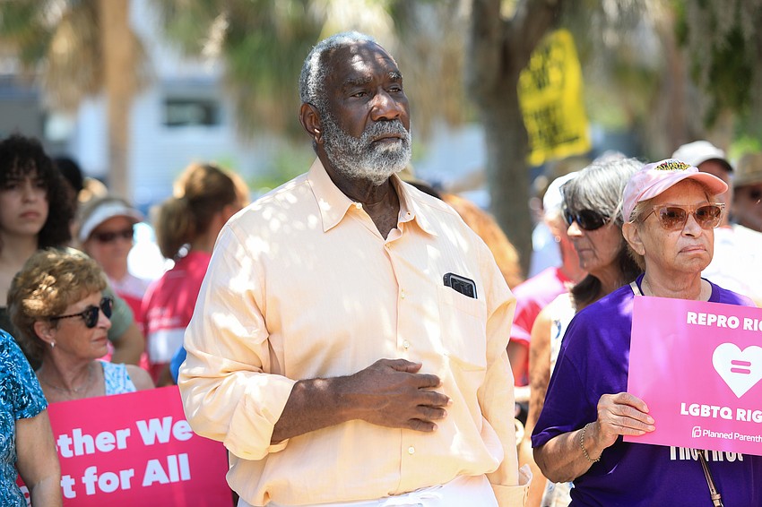 Fred Atkins watches on.