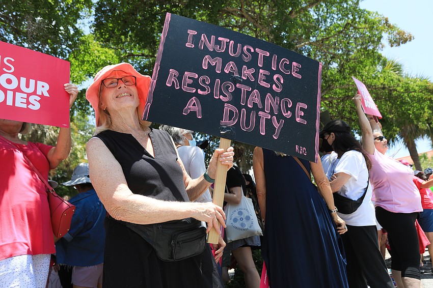Jean Rosenblum brings her own sign to the protest.