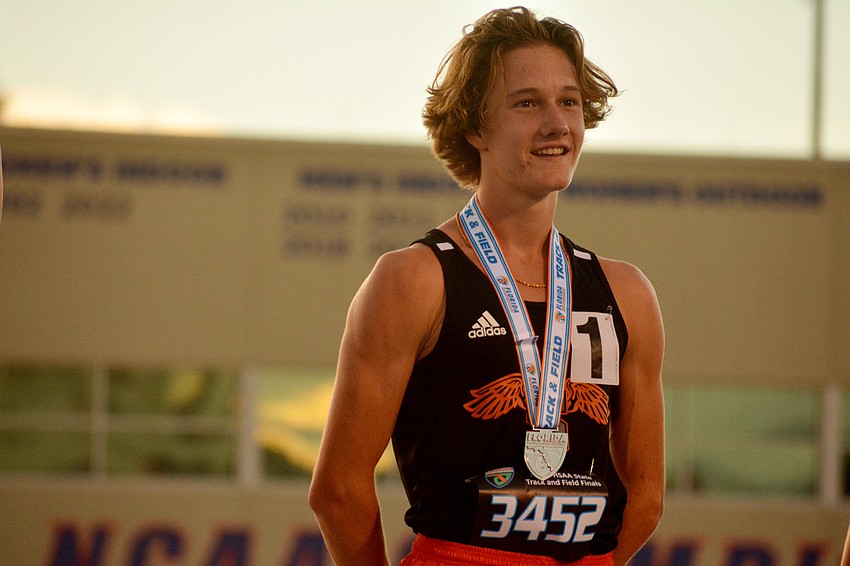 Sarasota High junior Alec Miller beams on the podium after finishing second in the Class 4A boys 1,600 meter run (4:13.50) at the FHSAA championships in Gainesville.