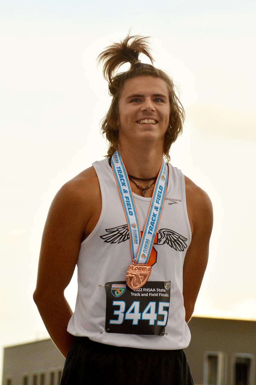 Sarasota High junior Tyler Boyer stands on the podium after finishing third in the Class 4A boys 110 meter hurdles (14.32 seconds) at the state track and field championships in Gainesville.