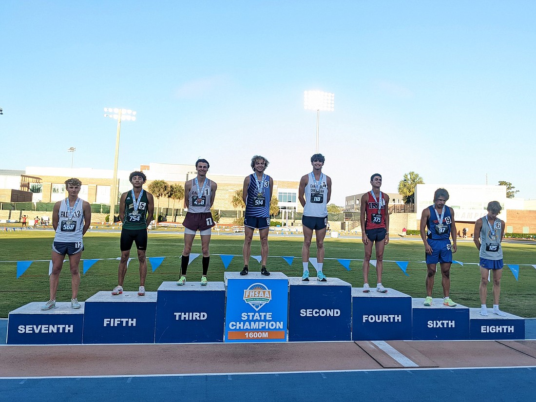 ODA senior Tristan McWilliam stands atop the podium after his 1,600 meter run in the Class 1A championships. McWilliam won the race in 4:17.97.