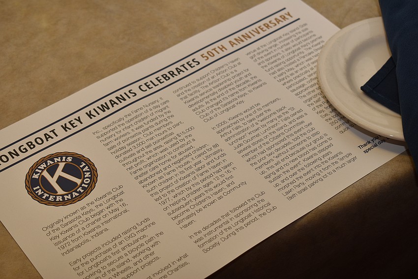 A history of the club served as a placemat for attendees.