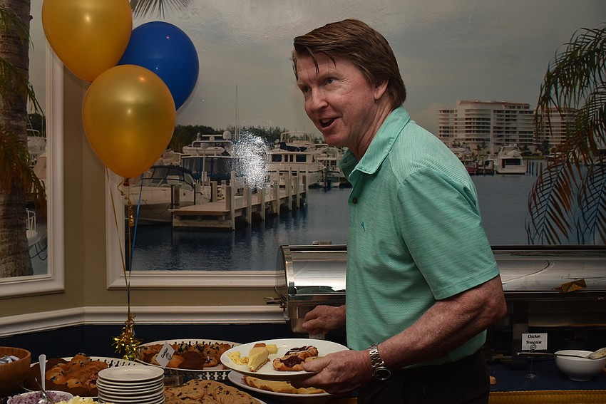 Member Earl Larson gets a buffet plate.
