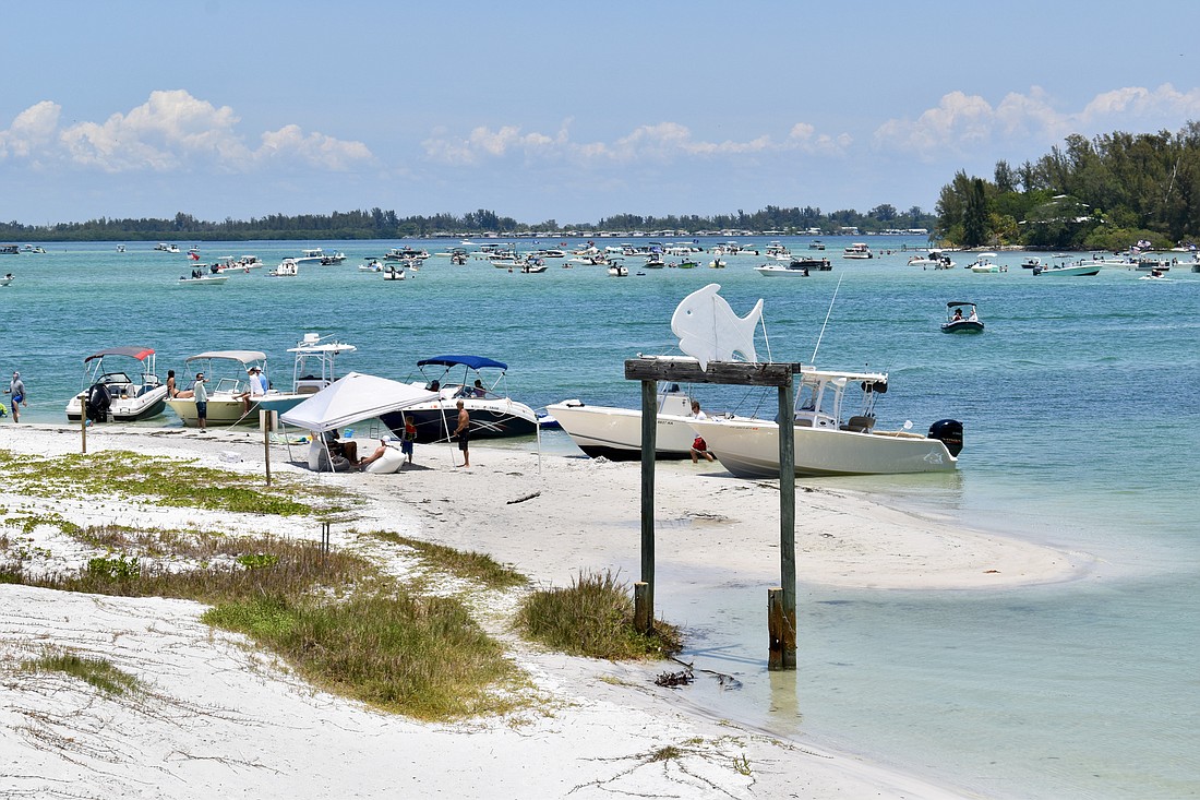 Boaters were gathered on the sand spit of Greer Island on May 14.