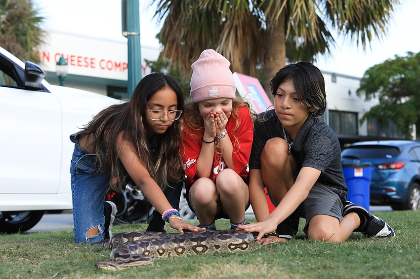 Olivia Kaster, Keana Mercado and Kenneth Mercado get acquainted with Coco.