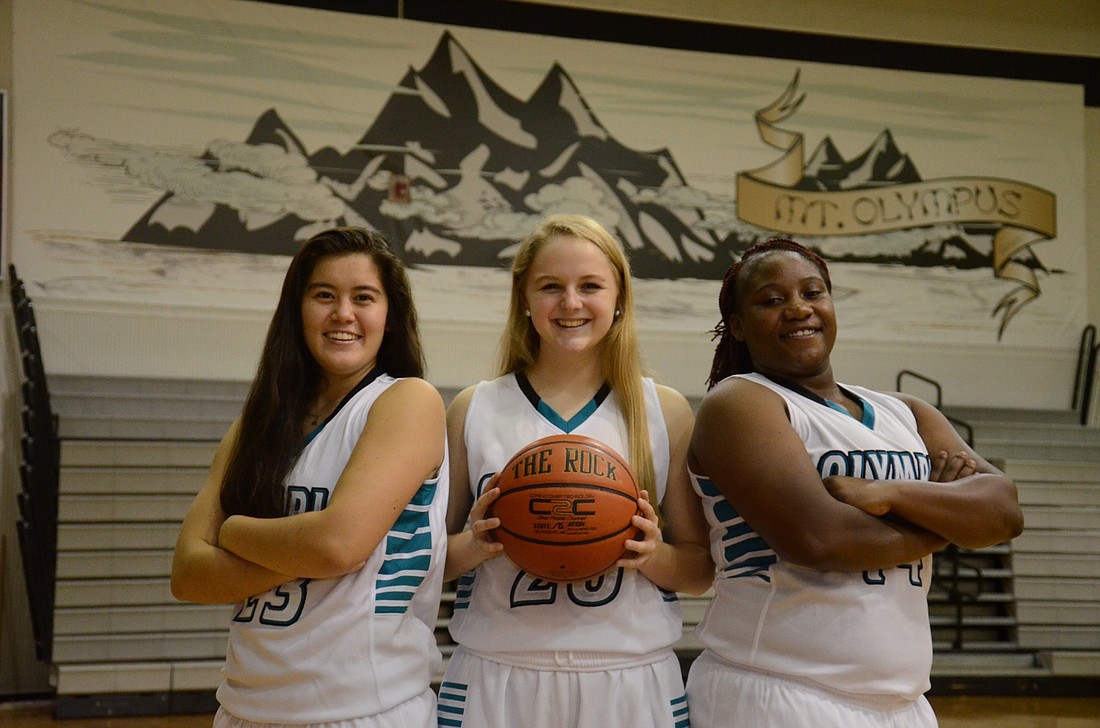 Natalie France, MacKenzie Loos and Umesha Beckwith, senior captains for Olympia High School, are looking to make history with Olympiaâ€™s basketball program this season.