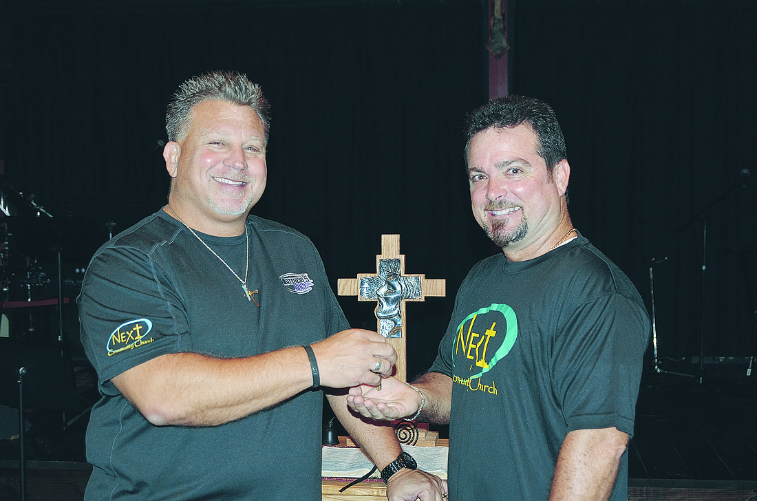 Pastor Scott symbolically hands the keys to Next Community Church to the new pastor, Sean LaGasse.