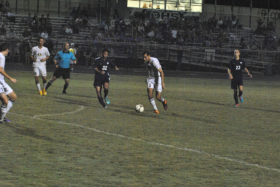 Daniel Aroujo attempts to dribble past Matias Mele for a scoring chance.