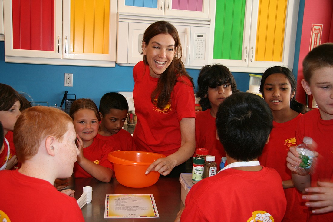 A Young Chefs Academy teacher works with her students.