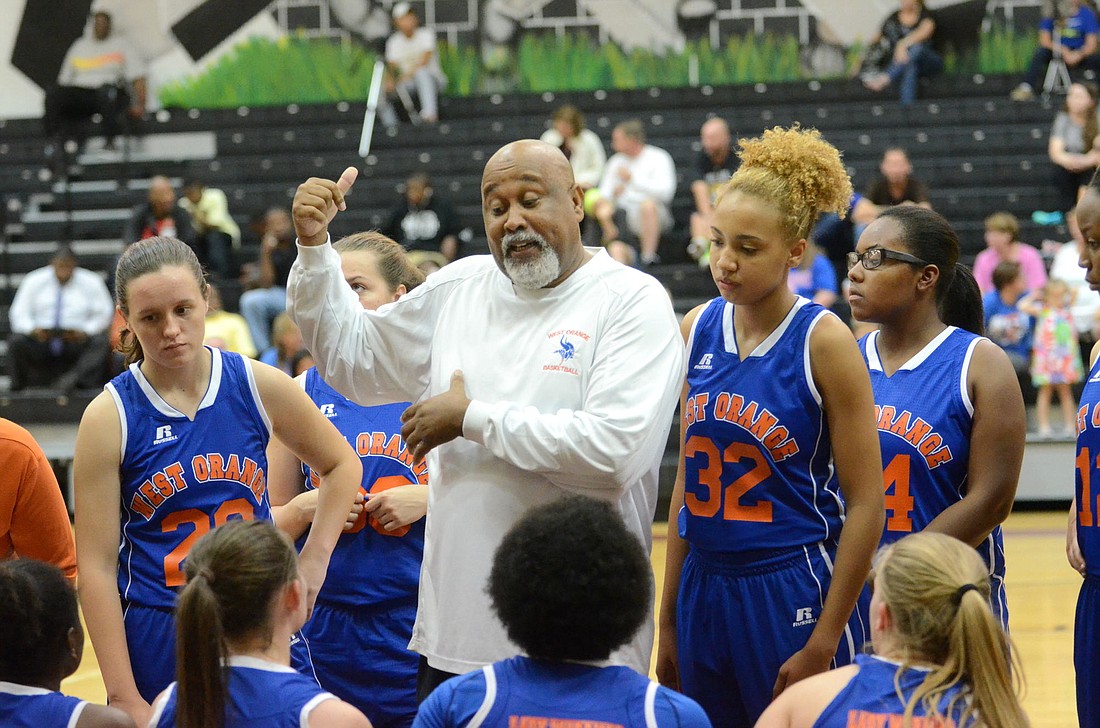 Veteran girls basketball coach Mark Oates, in his first year leading the program at West Orange, addresses his team during a timeout.