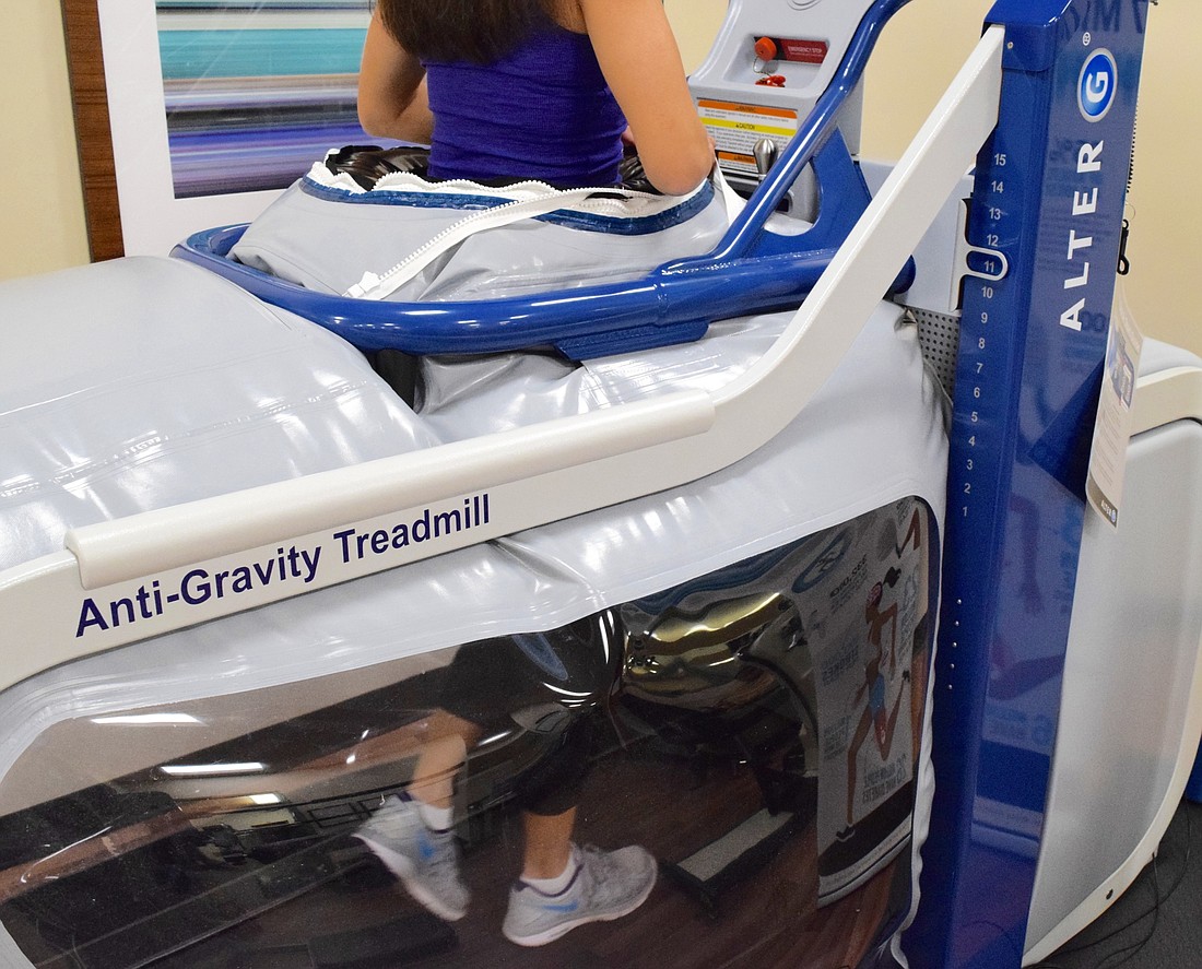 Physical therapist and Orlando Health Manager of Rehabilitation Services Kathryn Henderson demonstrates the AlterG.