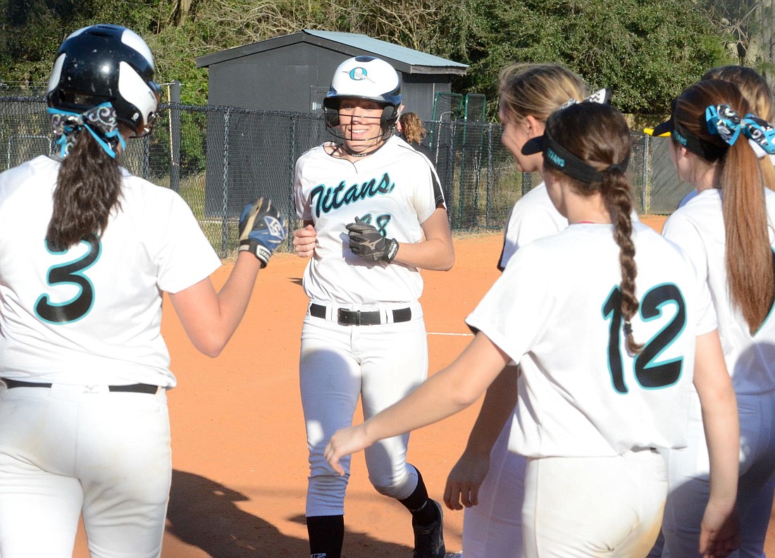 Olympia senior Jessica Lien is congratulated by teammates after hitting a home run Feb. 18 against Ocoee.