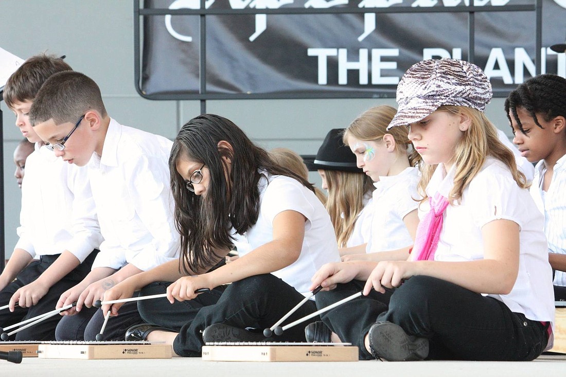 Students perform on xylophones at last yearâ€™s Arts and Jazz Festival.