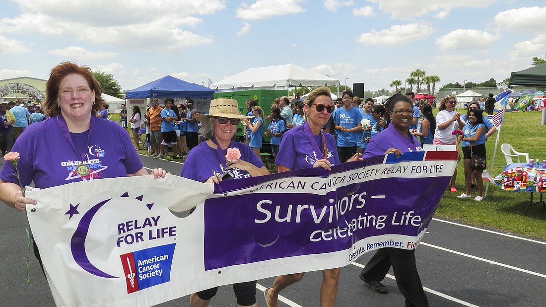 Teresa Wardingley, left, participated in the cancer survivorsâ€™ lap at the 2014 Dr. Phillips Relay for Life. (Courtesy Lockheed Martin.)