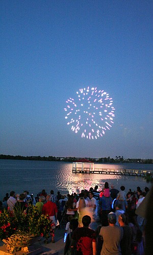 Photo by: G.K. Sharman - Fireworks sparkle over Lake Baldwin at Baldwin Park's Independence Day celebration July 1.