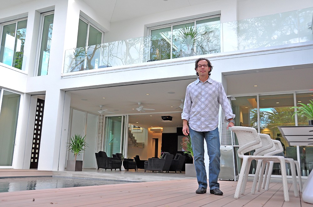 Photo by: Andy Ceballos - Designer Phil Kean stands on the back deck of his New American Home in Winter Park.