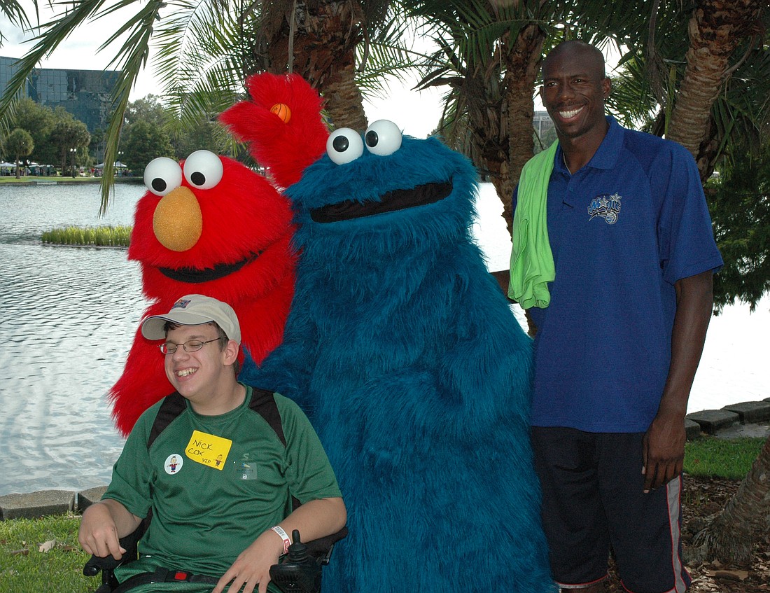 Photo by: Nathaniel's Hope - A VIP participant poses with Elmo, Cookie Monster and Bo Outlaw from the Orlando Magic at last year's Make 'm Smile event.