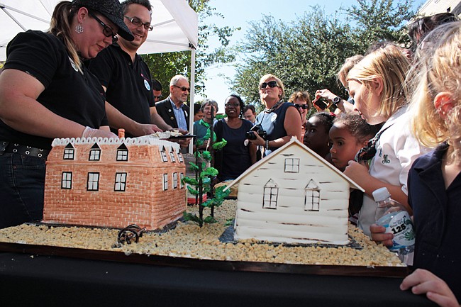 Photo by: Steven Barnhart - Residents literally chewed the scenery at Winter Park's 125th anniversary celebration, featuring a cake baked by The Flour Shop to look like the city in 1887.