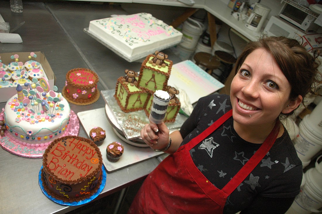 Photo by: Isaac Babcock - Senior cake artist Jennifer Malave shows off a push-up dessert shot, which Sprinkles Custom Cakes will sell at the Festival of Chocolate, where local chocolatiers face off against each other this Saturday.