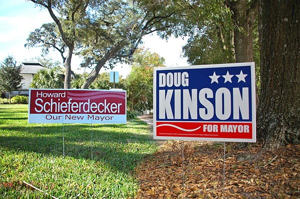 Photo by: Isaac Babcock - Schieferdecker and Kinson campaign signs dot city lawns. Yanchunis signs will go out this week. (Photo illustration)