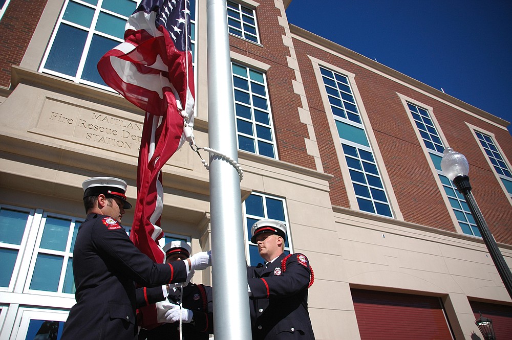 Photo by: Isaac Babcock - Firefighters raise the American flag for the first time in front of the new Maitland Fire Station No. 45, which was dedicated Jan. 19.