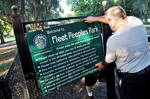 Photo by: Tim Freed - Winter Park employees on Tuesday morning remove signs from the park that bore Fleet Peeples' name since 1985. The park was stripped of its namesake after accusations arose that the longtime swim instructor had molested children o...
