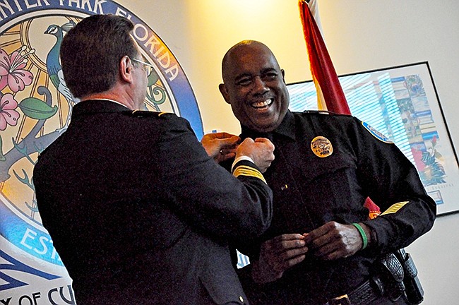 Photo by: Tim Freed - Winter Park Police Chief Brett Railey pins a new rank on newly promoted deputy chief Vern Taylor.
