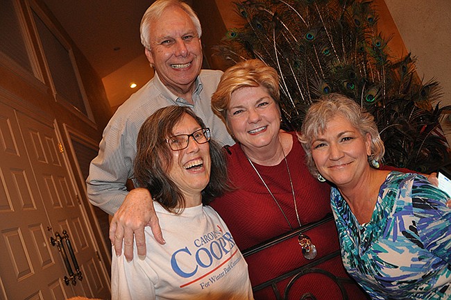 Photo by: Tim Freed - Carolyn Cooper, center, celebrates with Kathy Kiely, left, Ned Cooper, top, and Diane Homrich, right, after winning re-election.