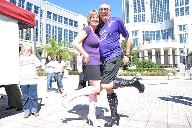 Photo by: Tim Freed - Men and women slipped on their highest heels for a walk through downtown Orlando to raise awareness of domestic violence.