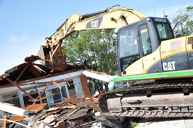 Photo by: Tim Freed - A bulldozer smashed the 52-year-old station on June 1, with the help of commissioners.