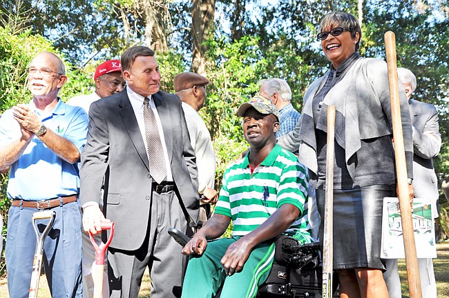 Photo by: Tim Freed - Sgt. First Class Bacary Sambou, center, prepares to break ground at his home Nov. 11.
