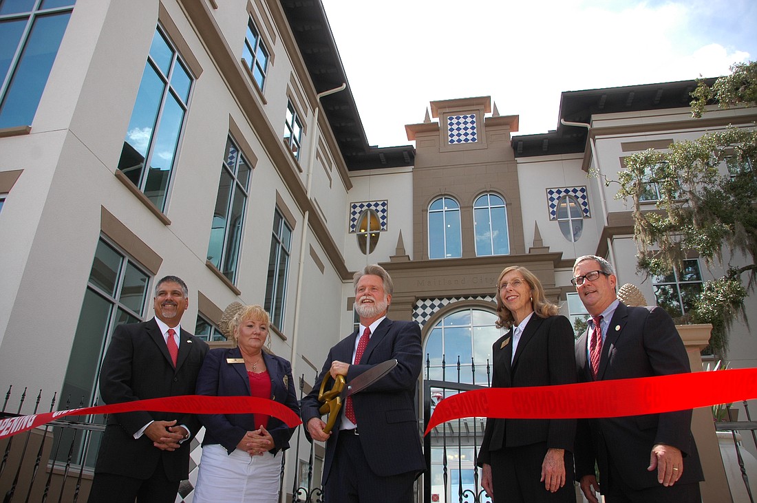 Photo by: Isaac Babcock - Maitland Mayor Howard Schieferdecker cuts the ribbon on the city's new City Hall Aug. 30.