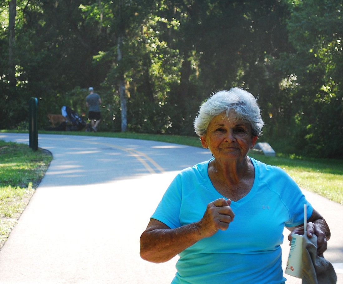 Photo by: Carmen Carroquino - Winter Springs mail carrier Alice Everard, 73, is training for a New York City marathon that benefits breast cancer research. She lost her husband and two other family members to cancer, and her daughter has breast cancer.
