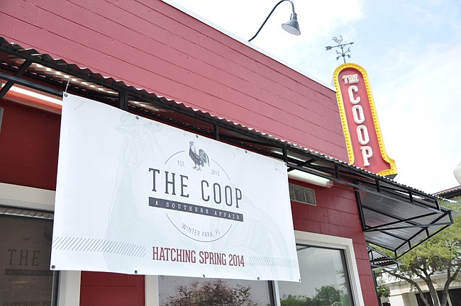 Photo by: Tim Freed - Signs of an impending opening hang over The Coop, founded by Winter Park's John Rivers.