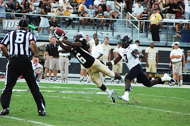 Photo by: Isaac Babcock - UCF receiver Rannell Hall leaps to catch a pass from quarterback Blake Bortles. Hall picked up 63 yards receiving and 93 yards on kickoff returns in the Knights' 33-20 win over Florida International University.