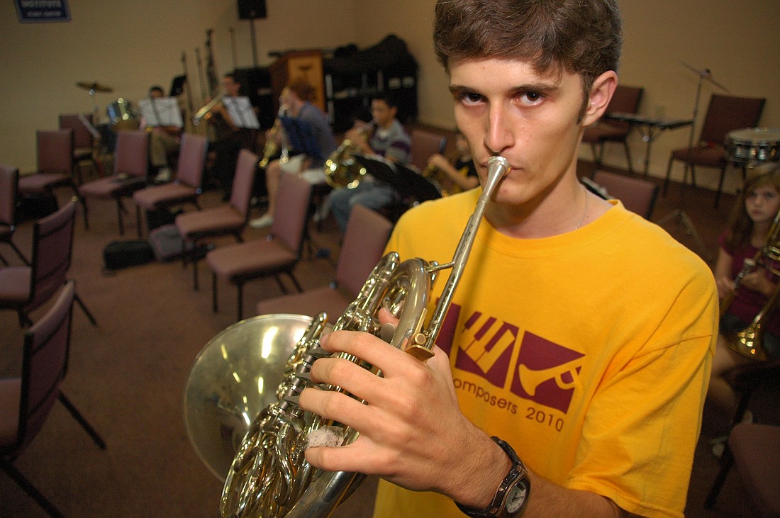 Photo by: Isaac Babcock - Winter Park resident Joe Prior practices the French horn at Covenant Church. Last month, his winning composition was played by the Orlando Philharmonic Orchestra.