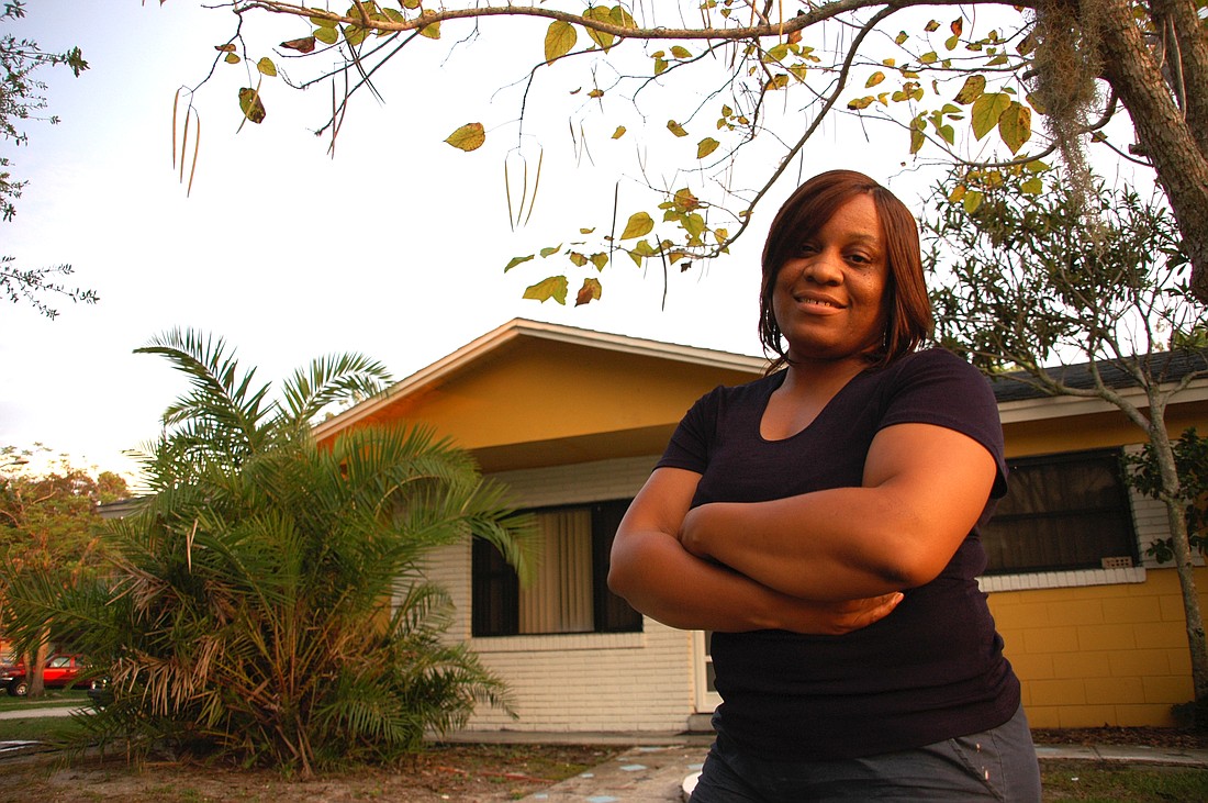 Photo by: Isaac Babcock - Vickie Johnson stands in front of her Altamonte Springs home that she's trying to keep from foreclosure.